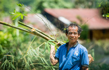 man carrying bamboo 