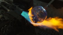 torch blowing flames on glass 