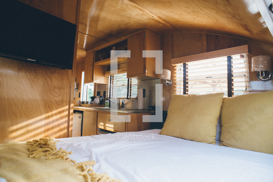 bed and kitchen in a camper 