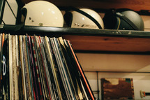 records and helmets on a bookshelf 