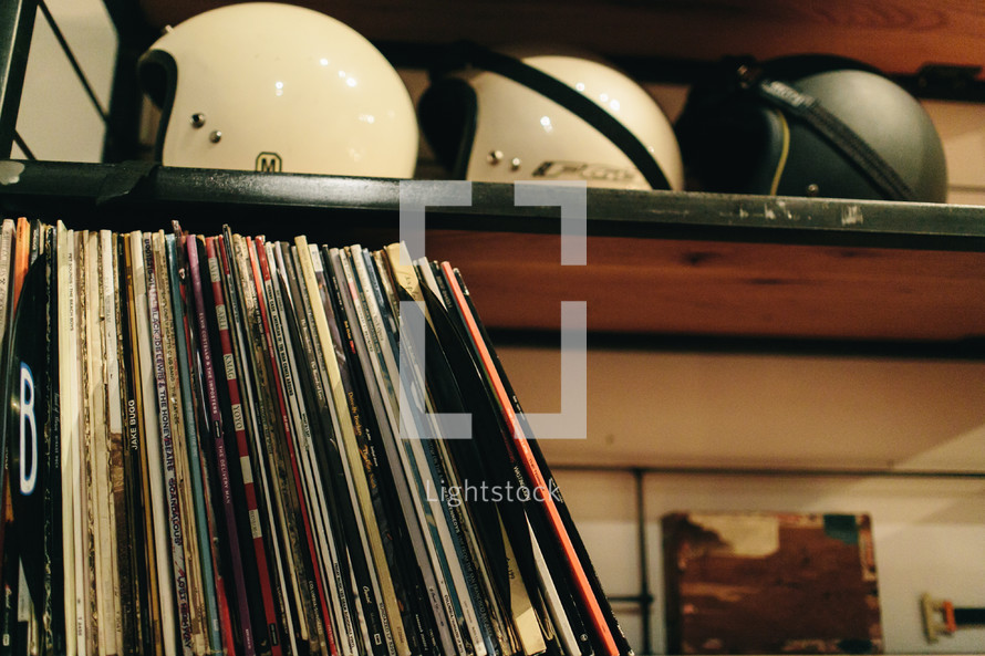 records and helmets on a bookshelf 