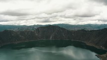Quilotoa Crater In Ecuador On A Cloudy Day - aerial pullback	