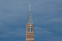 church bell tower and steeple against stormy sky