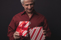 man opening a Christmas gift 