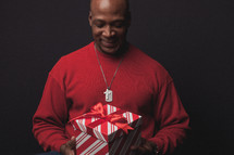 man opening a Christmas present 
