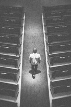 man walking down the aisle of a church