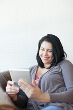 Latino woman looking at an iPad screen 