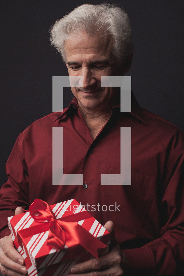 man opening a Christmas present