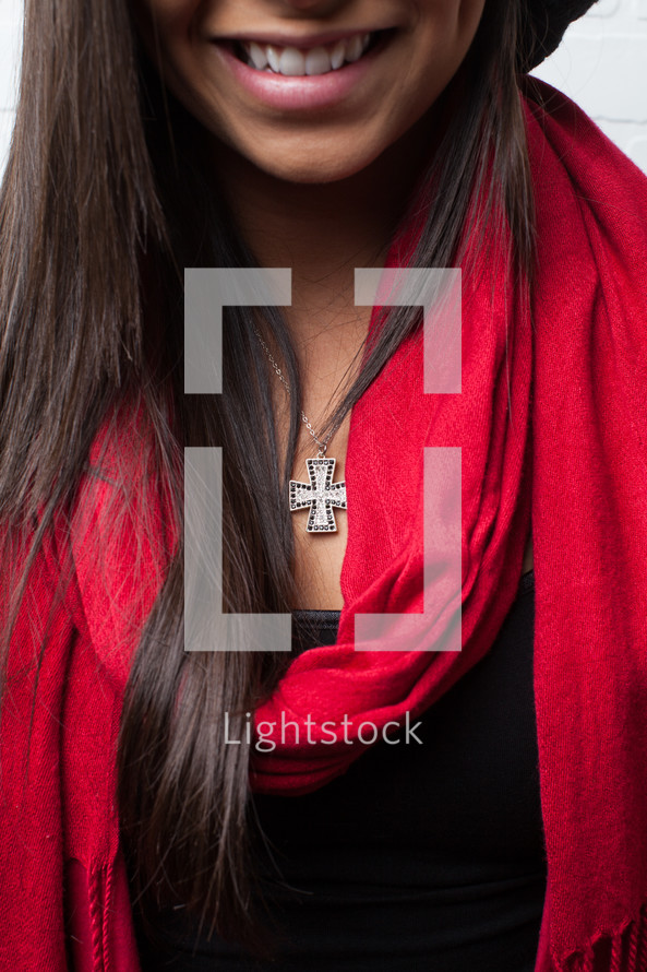 cross necklace and red scarf on an African-American woman 