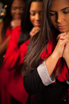 three African-American women with praying hands 