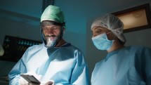 Doctor uses smartphone in surgery room