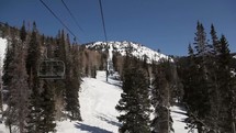 riding on a ski lift up a mountain 
