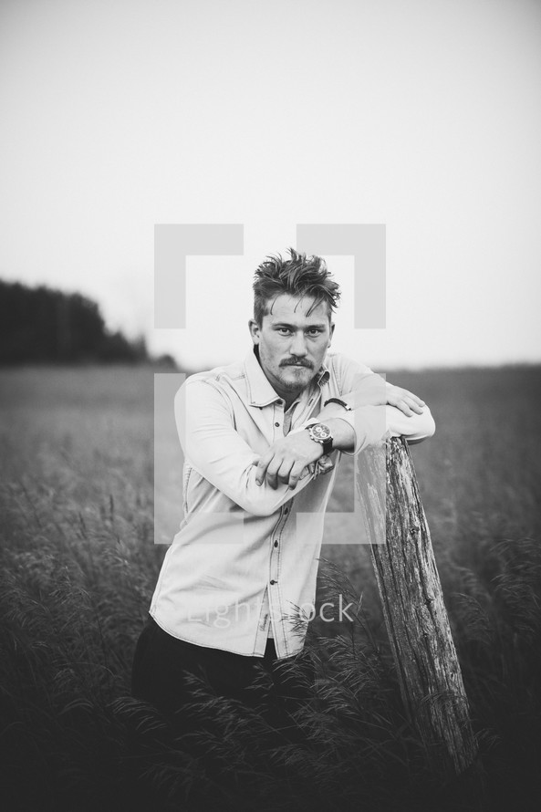 a man posing in a field 
