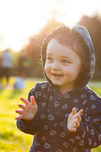 toddler girl plays happy in the park outdoors in the spring