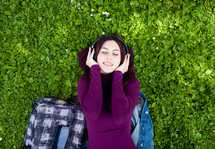young woman listening music with headphones in outdoor.