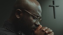 Faithful African American Priest Whispering a Prayer in Church