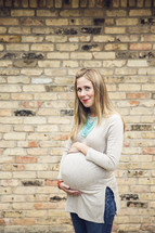 a pregnant woman holding her belly 