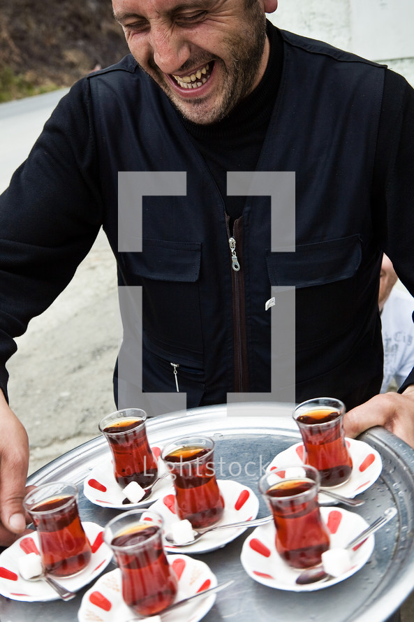 Turkish man offering tea