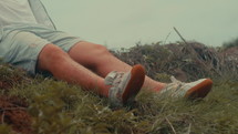 Man sitting on the grass at the sea
