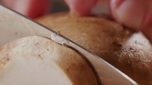 Macro Shot Of Cutting Mushrooms With A Knife