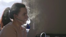 A Girl is Utilizing a Nebulizer to Cope with Her Respiratory Concerns - Close Up