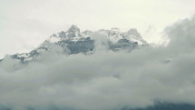Alps mountain with snow and clouds.

