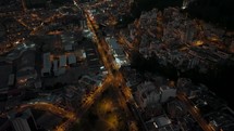 Nighttime twilight aerial reveals vast city layout of populous Quito, Ecuador	