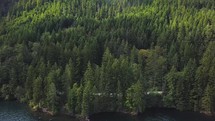 Aerial view of a beautiful freshwater lake, a mountain range, and forest.