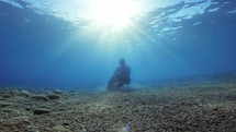 Soldier holds his breath underwater