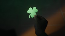 Holding A Green Clover in the night 