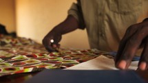 seamstress sewing African Fabric in Uganda 