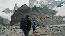 Backpacker Couple On Mount Fitz Roy Trail Near Laguna de los Tres In El Chalten, Patagonia, Argentina. slow motion