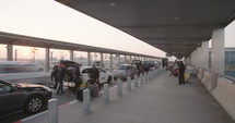Timelapse of passengers arriving with cars to the terminal at the airport