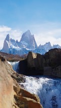 Mount Fitz Roy showing though secret waterfall in Patagonia Argentina, El Chalten town. Vertical shot
