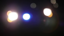 Flashing red and blue lights on cop car, police officer vehicle at night.
