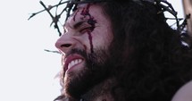 Low angle close up of Jesus in pain on the cross
