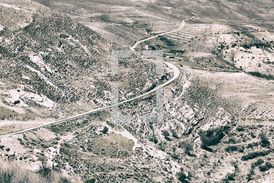 winding road through a desert view from castle ruins 