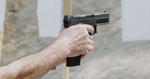 Pistol shooting bullets in slow motion footage. Hand guns in firing range