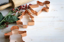 cooper Christmas cookie cutters on a white wood background 