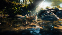 A lost crown lays in the shallow river bed as light eluminates it. Sonship and inheritance restored. 