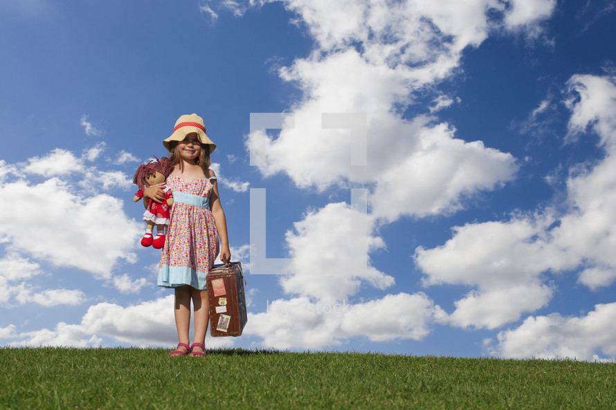 Girl holding vintage suitcase	