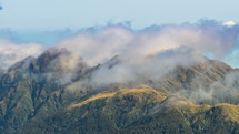 Misty clouds moving fast over beautiful mountains ridge in New Zealand wilderness nature Time-lapse
