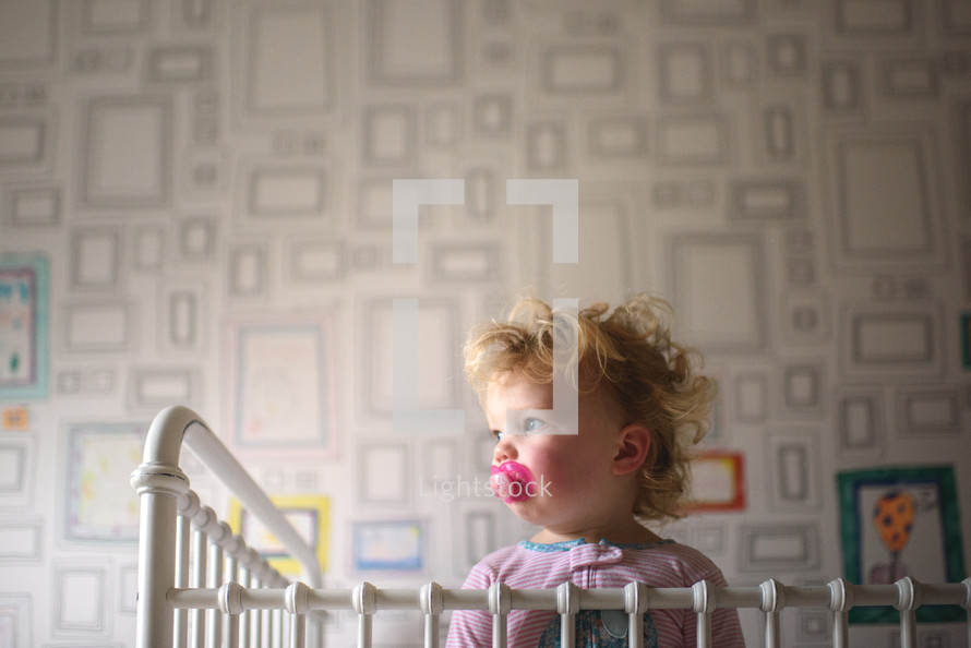 toddler girl in her crib 