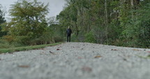 a man walking on a trail 