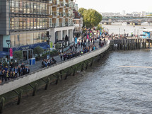 LONDON, UK - SEPTEMBER 29, 2015: Tourists walking on the River Thames South Bank