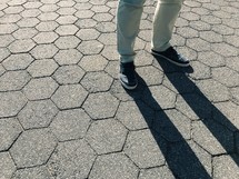 a man standing on a stone pavers 
