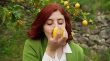 Woman smelling a lemon.