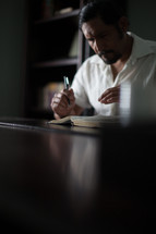 Man at a desk studying the Bible.