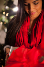 An african-American woman holding a Christmas gift 