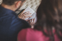 husband and wife reading a Bible together 
